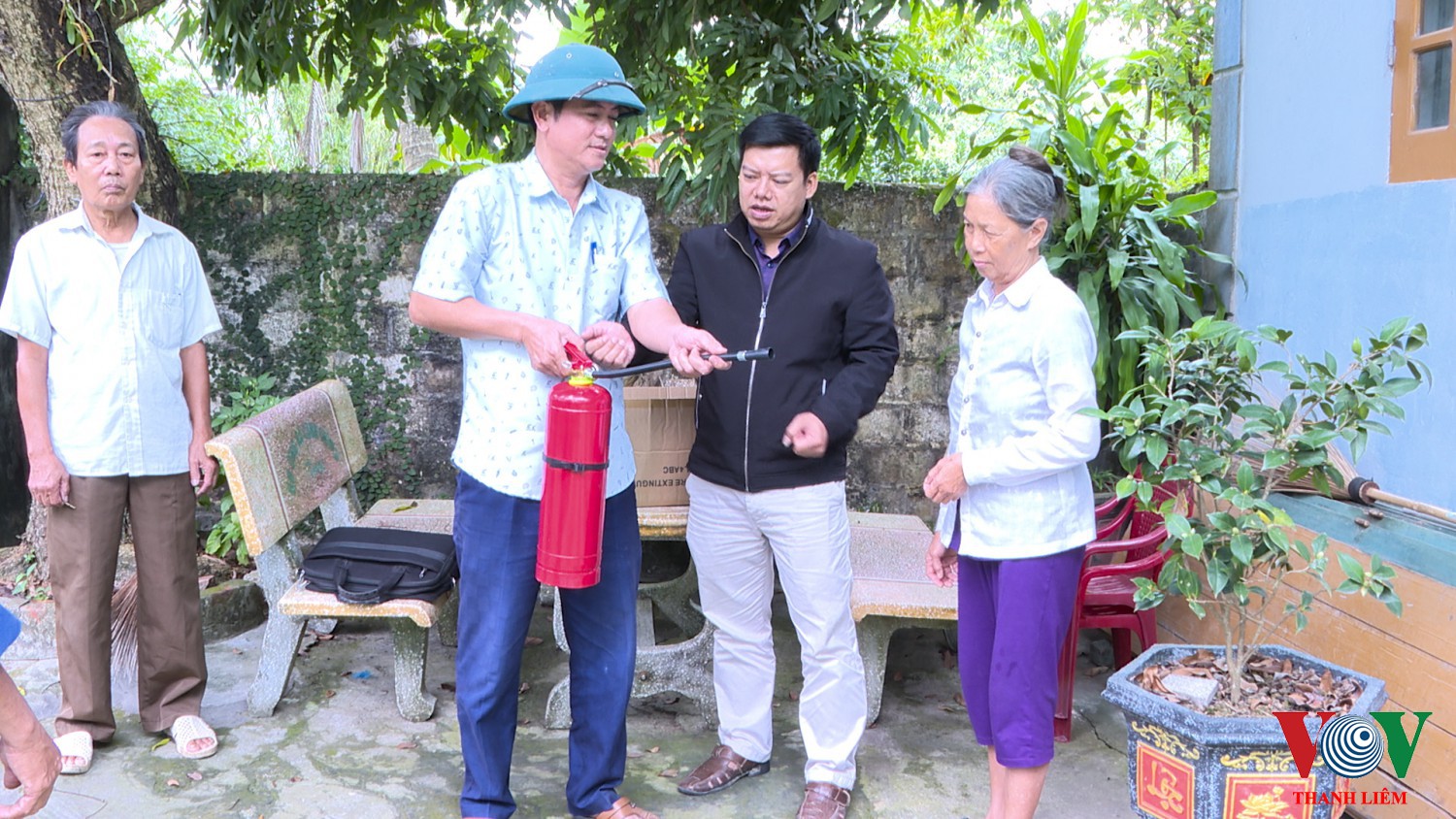 Trao tặng và hướng dẫn nhân dân sử dụng bình PCCC. Ảnh Kim Dung